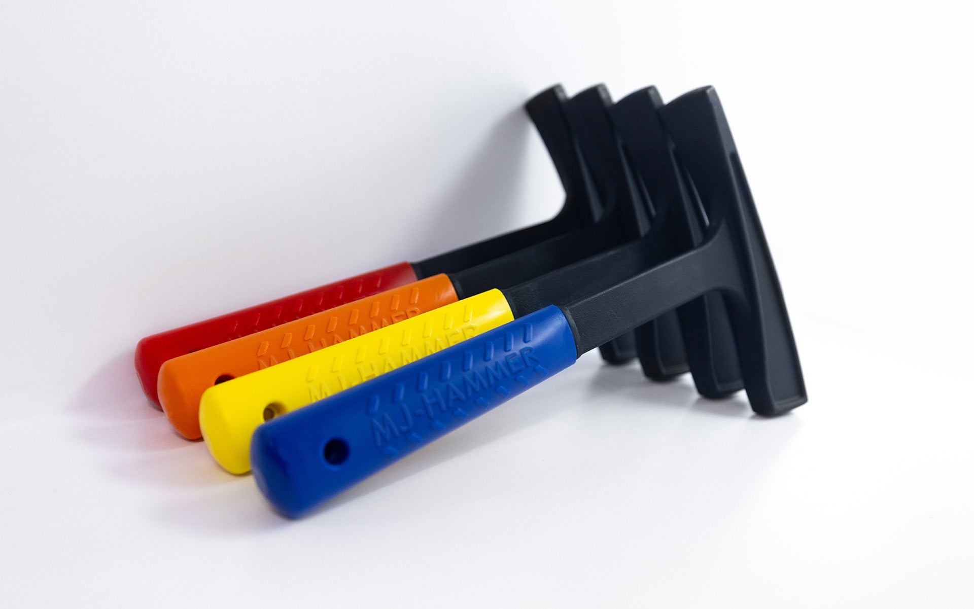 4 hammers positioned next to each other against a white background, each having a bright solid colored handle such as red, orange, yellow, and blue